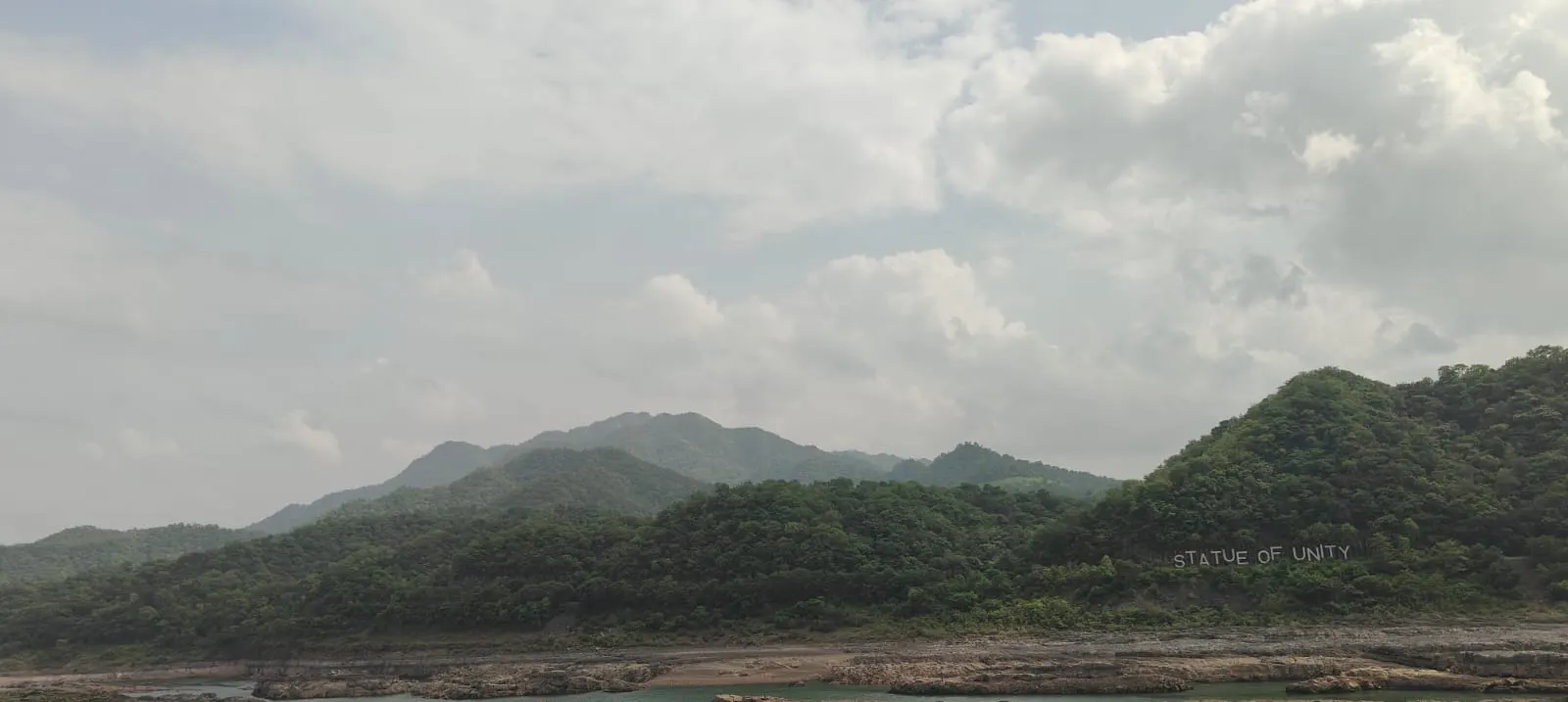 Hillside 'Statue of Unity' signage overlooking the Narmada river valley, Gujarat