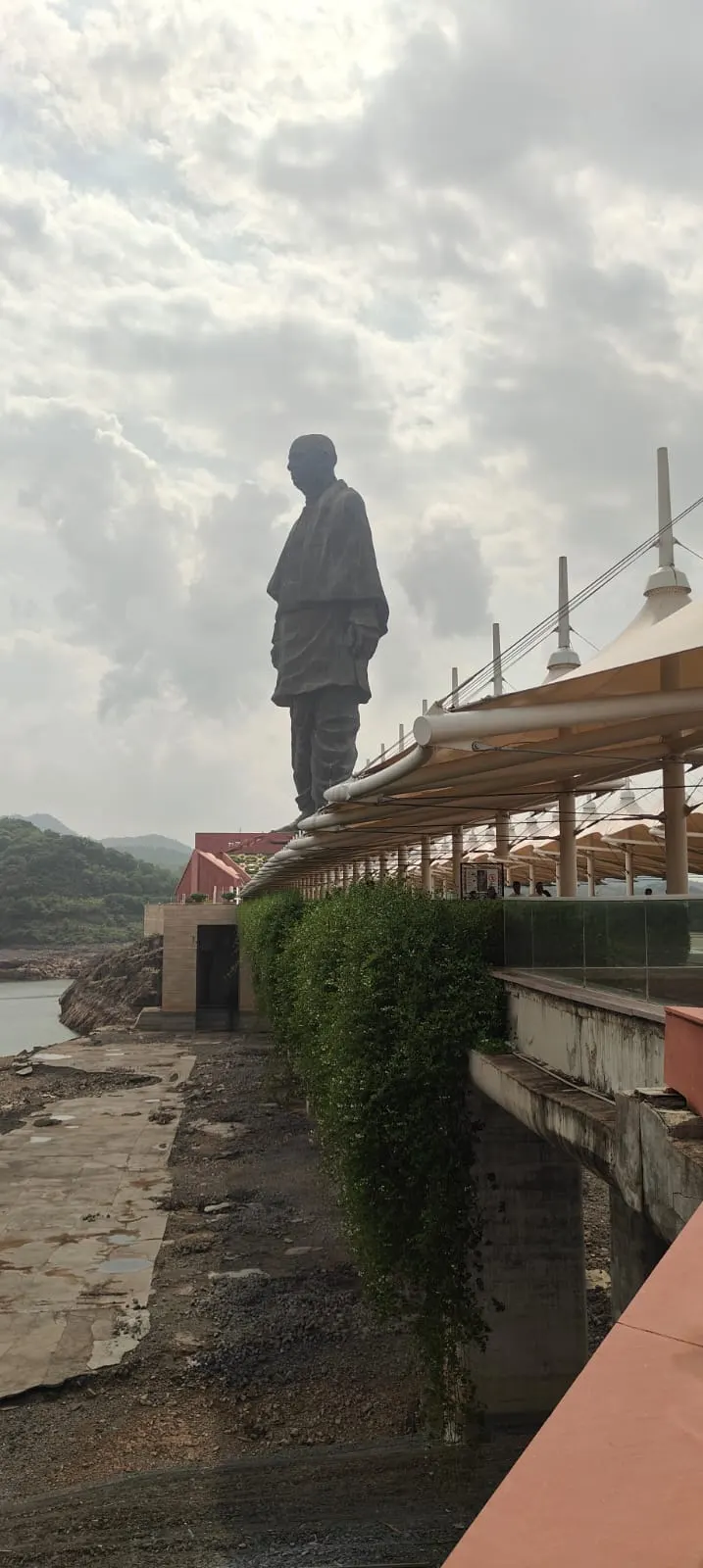 Full view of the Statue of Unity against a cloudy sky, Gujarat