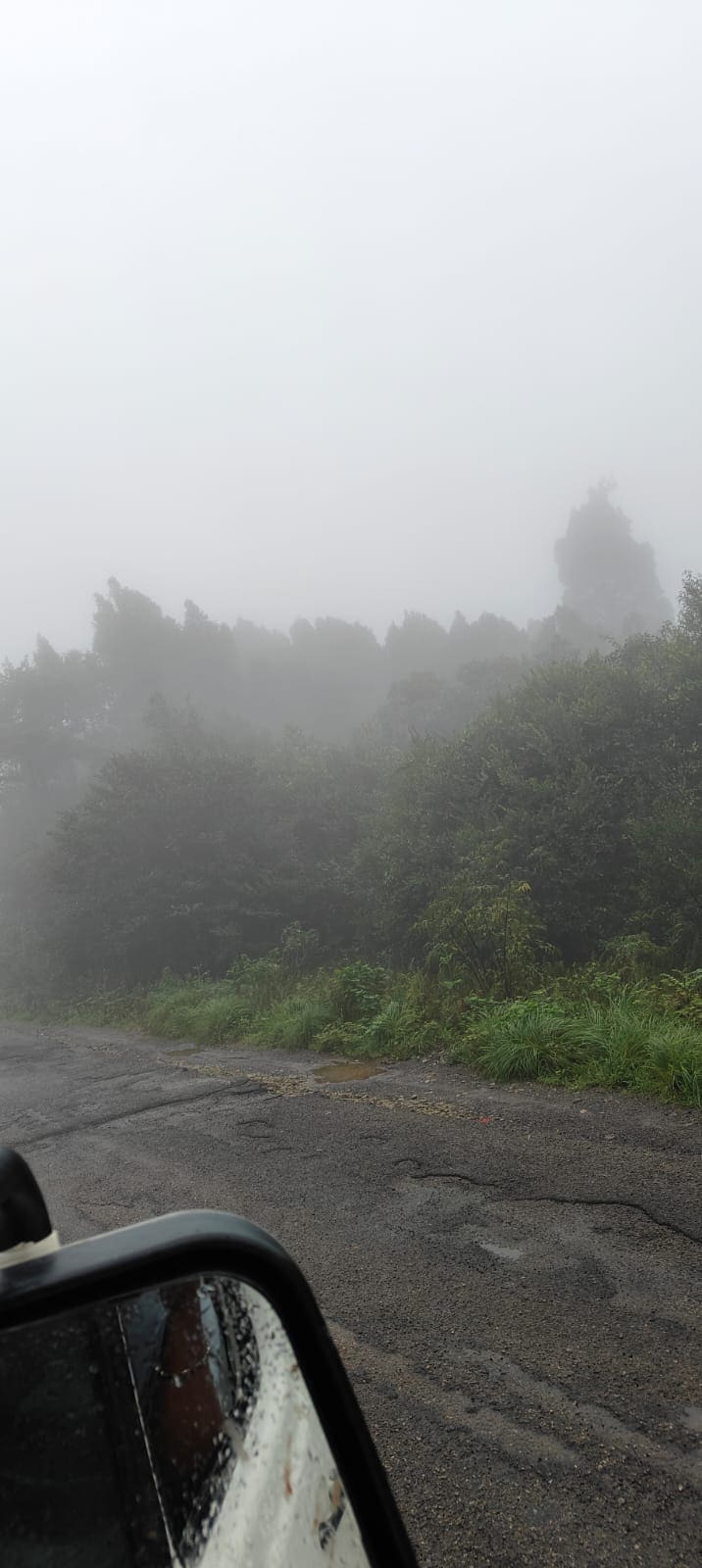 Foggy mountain road winding through the hills