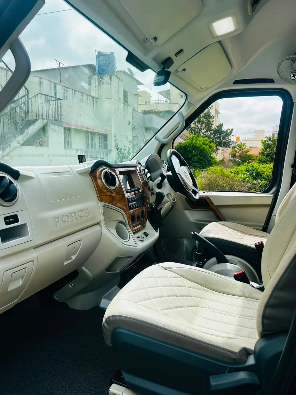 Executive cockpit with ivory dash, wood-finish center console and infotainment screen