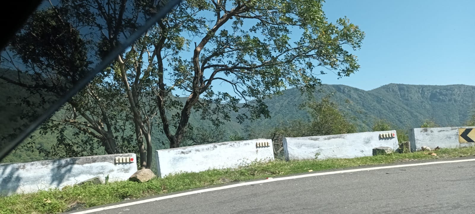 Wide panoramic view of hills from a ghat road stop