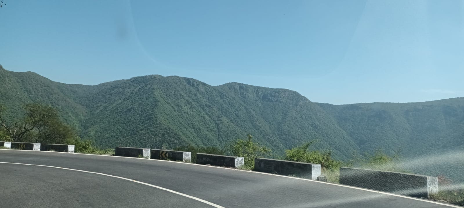 Layered mountain ranges seen from a ghat road viewpoint