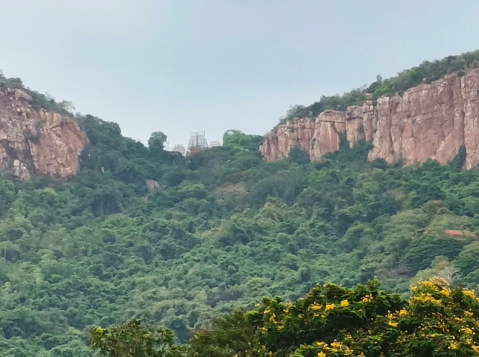 Temple tower visible between the rocky Tirupati hills