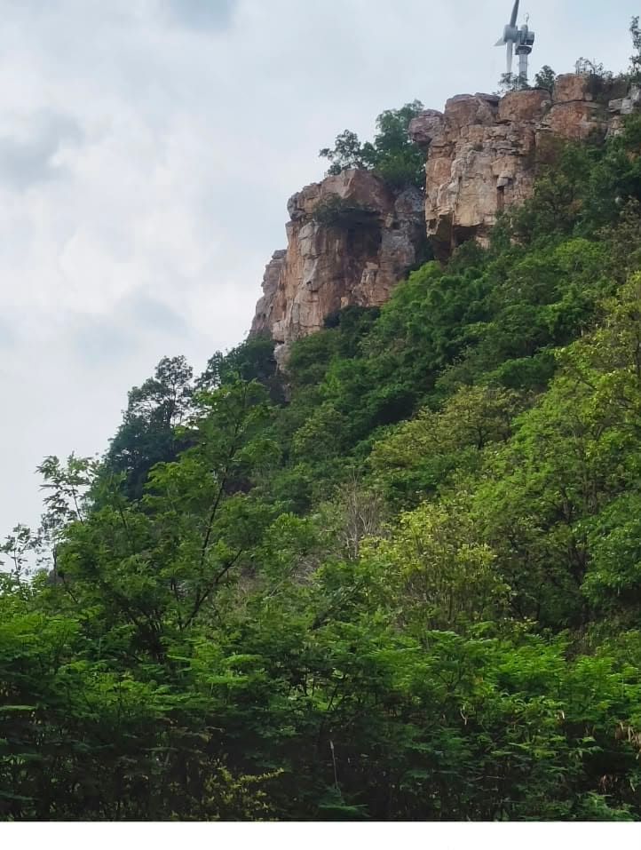 Rocky hilltop cliff with a windmill structure near Tirupati